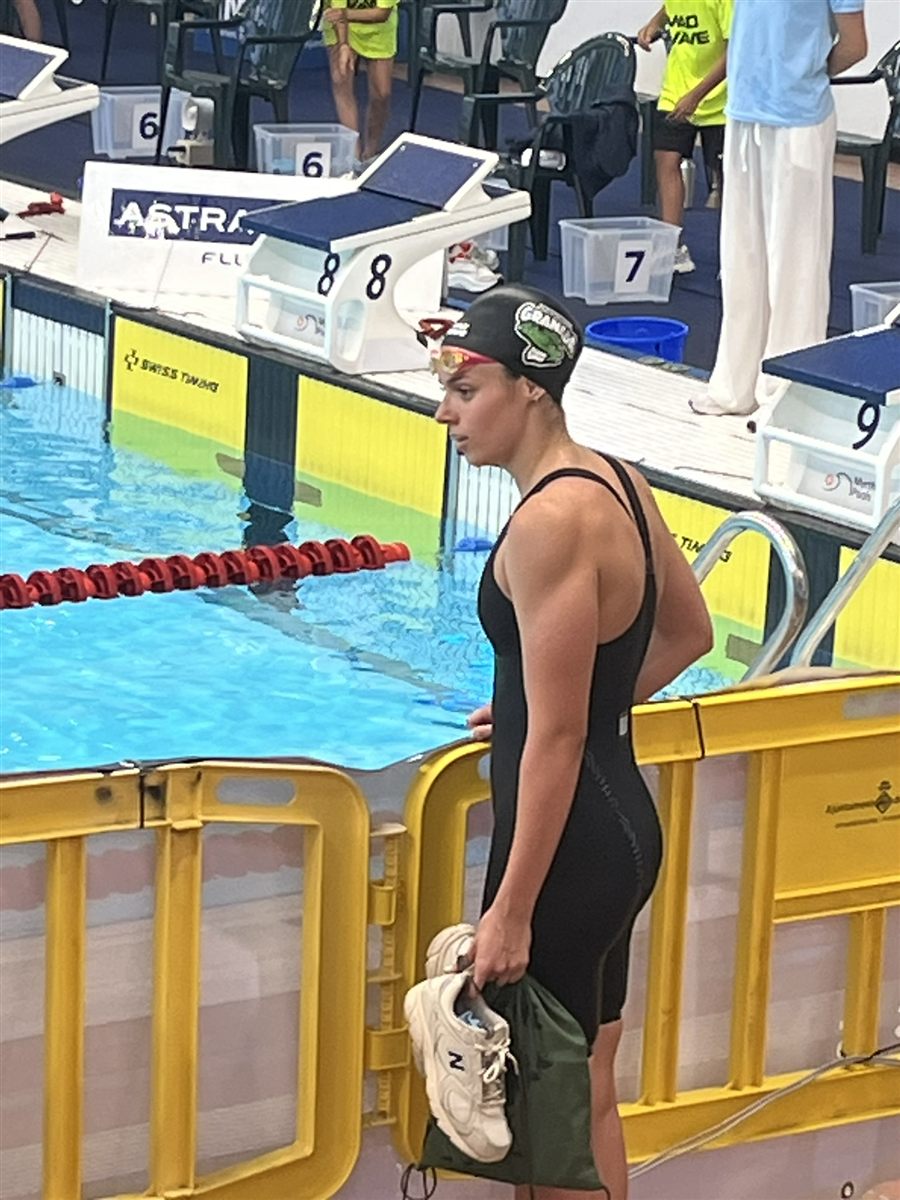 Zoë in a green cap and black swimsuit at the Open Trials pool
